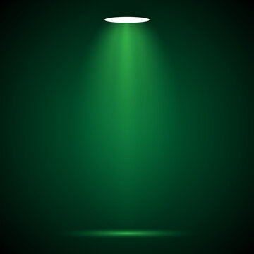 A single spotlight illuminates a dark green background creating dramatic contrast