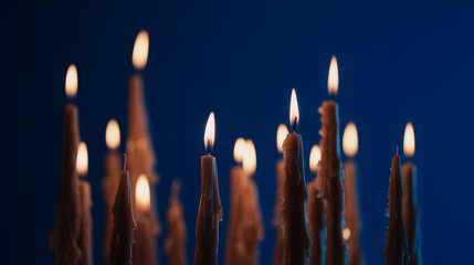 wax. Colorful tapered candles drip wax onto a dark blue surface, glowing softly in warm light. event programs, museum guides, designed for cultural heritage projects and event programs.