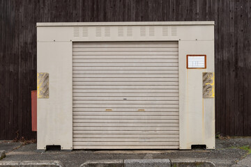 A closeup shot of automatic metal roller door used in factory, storage, garage, and industrial warehouse. The corrugated and foldable metal sheet offer space saving and provide urban and rustic feel