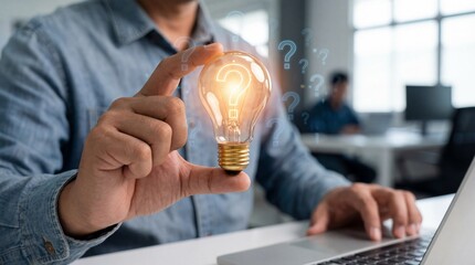 a man holds a glowing lightbulb in his hand symbolizing innovation and new ideas amidst a modern office setting high quality