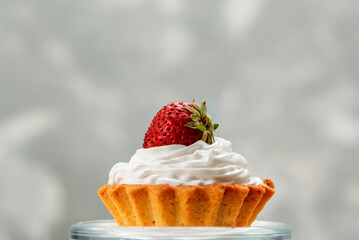 Sweet Strawberry Tartlet with Whipped Cream on a Clear Stand