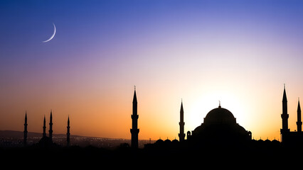 A majestic mosque silhouette against a vibrant twilight sky with a crescent moon