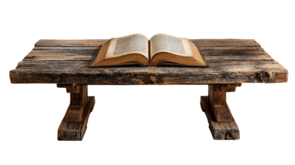 Ancient open book resting on rustic wooden table with weathered texture and historical literature details isolated on white background