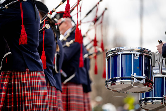 Fife and drum performance group in traditional clothing perform Irish music at St. Patrick's Day holiday celebration