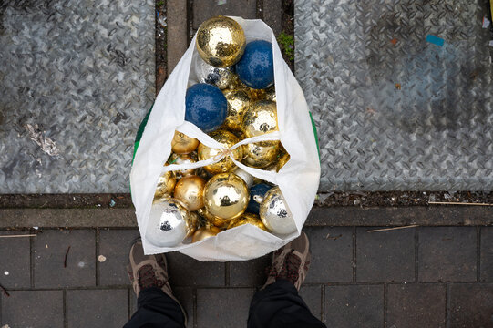 Discarded shopping bag with Christmas ornaments after New Year in Jette