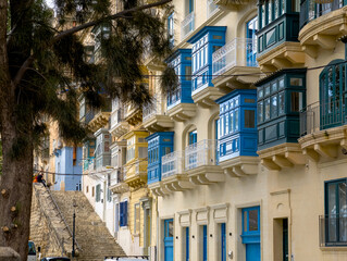 Valletta old town narrow street with traditional Maltese balconies and limestone facades
