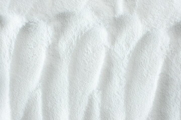 Soda powder sodium bicarbonate surface. Abstract white background. White texture with wavy patterns...