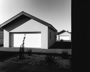 Black and white image of modern garages with white doors