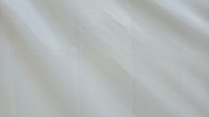 The white canvas is wrinkled and creased. White fabric texture with wrinkled texture. Wrinkles and texture for background or design element, texture, and background.