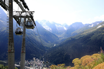 Cable car with gondolas moving along mountain range background