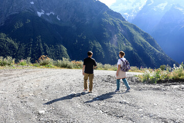 Man and woman walking on gravel road