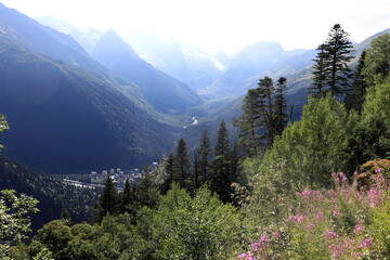 Mountain valley view with river and village