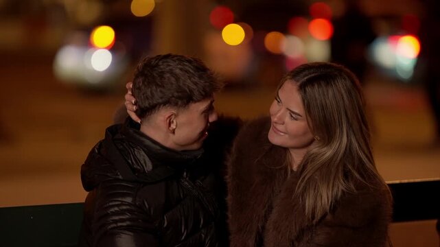 A romantic couple in Paris at night The woman playfully teases the man by making bunny ears behind his head Bokeh lights create a warm romantic atmosphere in the background The scene captures love and