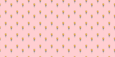 Seamless pattern of small yellow tulip flowers on a soft pink background