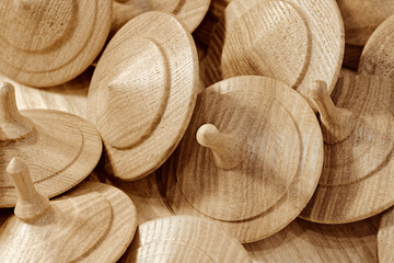 A lot of toy wooden spinning tops
