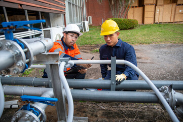 Engineers checking pipeline system for maintenance and safety inspection