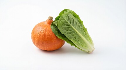 Freshly harvested orange pumpkin and vibrant green romaine lettuce on a white background