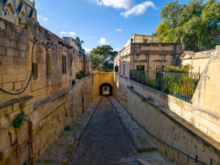 alletta old town lane with limestone walls and shaded archway