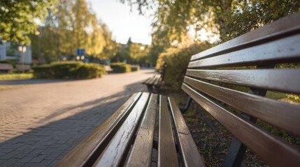Fototapeta premium empty city park bench in morning light, calm silence, new beginning concept, realistic photo, soft shadows, wide frame