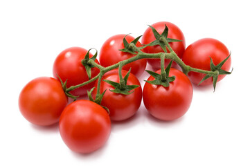 Fresh vibrant red cherry tomatoes on the vine, ready for healthy cooking and eating