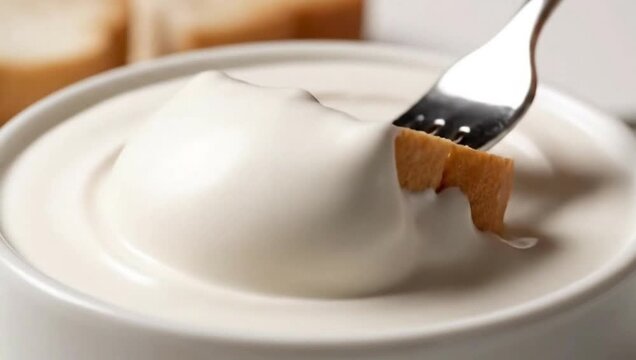 Close Up of Bread Dipping into Creamy White Sauce Appetizing Food Texture Shot 4k Video