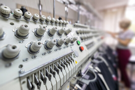 Stitching logos on restaurant uniforms with embroidery machine