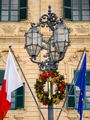 Governor's Palace with Christmas wreath and festive decorations on lamppost, Valletta, Malta