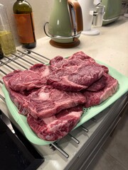 fresh Black Angus Prime raw beef steakes ribeye striploin, chuck roll and picanha on wooden cutiing board