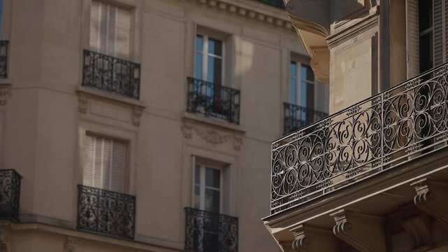 Close-up shot of Parisian architecture featuring balconies and windows of a classic French building The video showcases ornate ironwork and provides an establishing shot of a romantic cityscape in Par