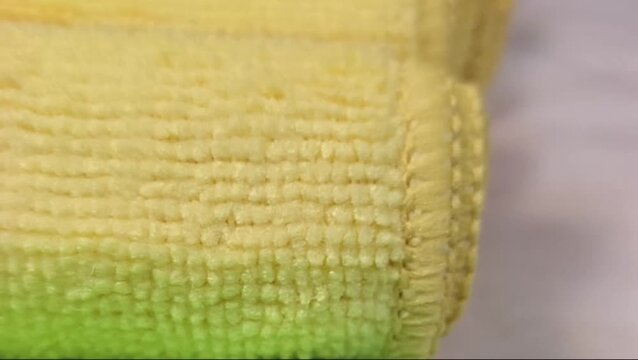 Macro close-up of soft microfiber fabric textures in various colors showing fiber details and stitching