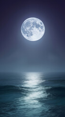A bright moon hangs in the night sky over the ocean. Waves gently roll towards the shore, reflecting the light of the moon on the water&rsquo;s surface