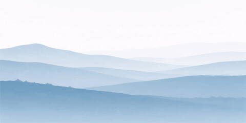 Obraz premium A breathtaking sunrise illuminates a misty mountain landscape as golden light filters through morning fog and clouds over the snowy forest hills and valley at dawn