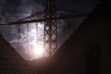 Bright firework explosion behind power transmission tower at night, New Years Eve Silvester 2025