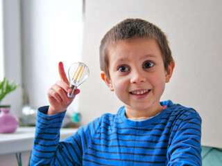 Enthusiastic Young Boy Gesturing a Bright Idea with a Lightbulb in STEM Concept - coding, science, or creative thinking courses