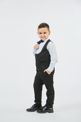 A boy in a classic formal suit on a white background