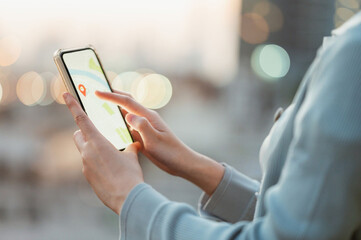 Woman using smartphone with map application to find location