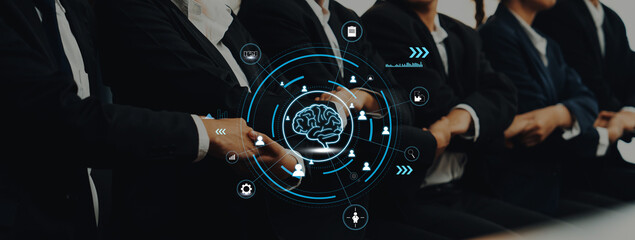 A group of business professionals dressed in suits discusses ideas while a digital brain interface showcases technology impact on modern work environments. Trope