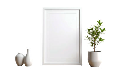 White framed artwork between two vases and a potted tree, all against a dark background