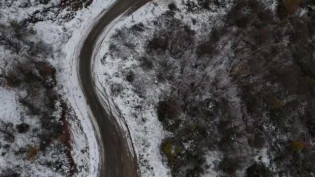 A quiet road stretching through natural surroundings, leading into the distance and creating a strong sense of direction and journey. The scene conveys freedom, movement, and exploration, with a calm 
