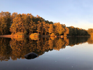Picturesque rural landscape in late autumn, houses, dramatic sky, sharp roof ridge in the foreground