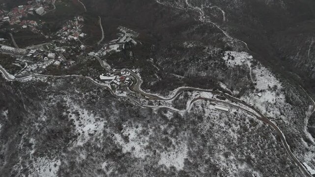 A serene winter landscape of the snow-covered mountains in Termal, Yalova, featuring white snowy peaks and dense pine forests. The peaceful natural scenery captures the beauty of the Turkish winter, m