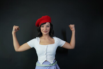 A young woman is demonstrating her strength. The concept of strength and self-confidence.