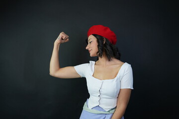 A young woman is demonstrating her strength. The concept of strength and self-confidence.