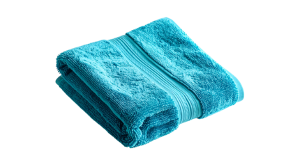 A folded teal bath towel against a black background