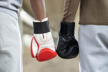 A close-up of boxing gloves displayed side by side, representing the spirit of competition and togetherness in sportsmanship.