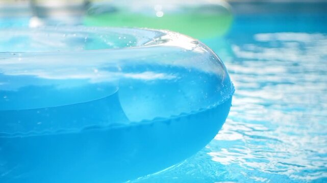 Blue and Green Pool Float on Swimming Pool Water Background