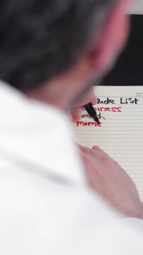 Gratitude List Journals Concept - Gray Haired Middle Aged Man Writes in Journal About What He is Grateful and Thankful For in Life