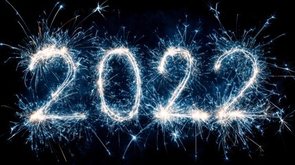 Festive image showcasing the year 2022 illuminated with sparks against a dark backdrop. The number's light emits brilliant bursts