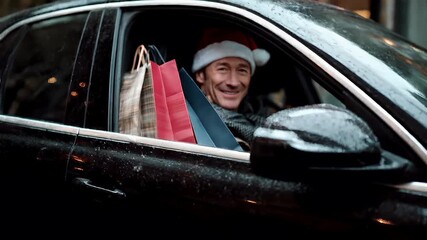 A man in a Santa hat sits in a car, wearing a festive hat and scarf, with shopping bags in hand. The scene is set against a backdrop of a snowy urban environment.
