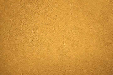 peach fuzz yellow brown cement in plaster concrete wall texture background, cement wall backdrop. Textured Plaster Wall Background. A close-up of a textured plaster wall with an abstract rough surface